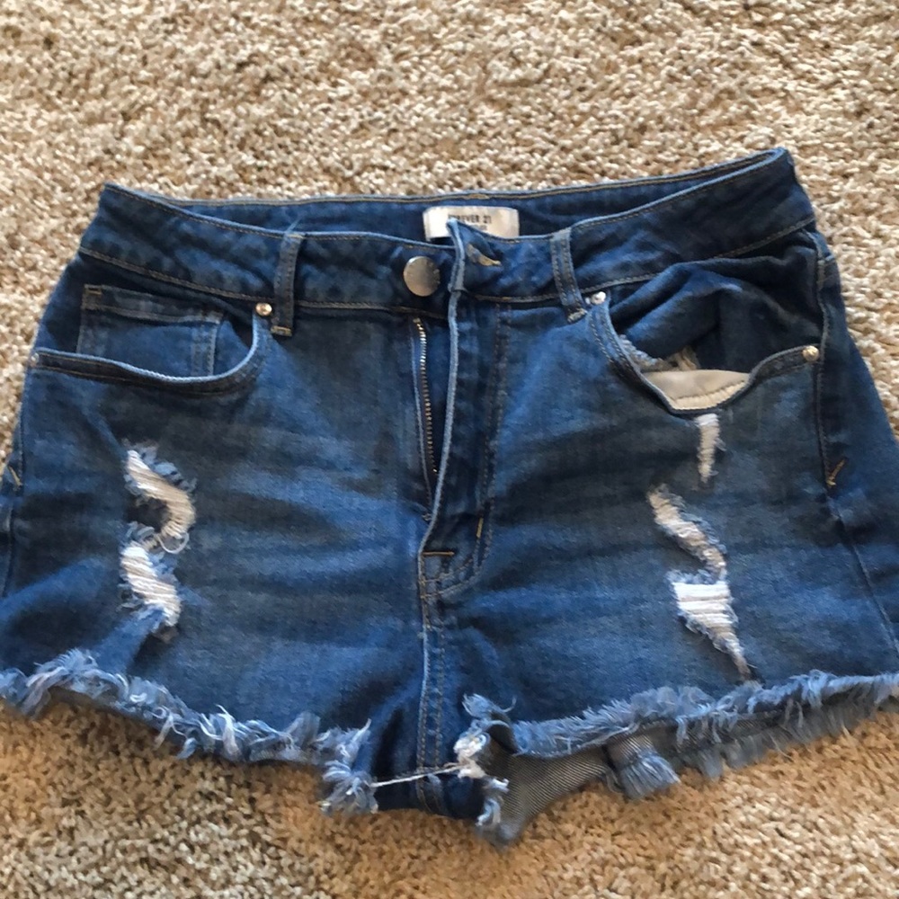 high rise medium wash fringe shorts